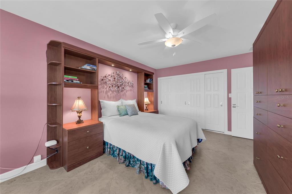 4420 Exeter Drive, Unit 307 Longboat Key, FL 34228 - Photo 14 of 37 a bedroom with a large bed and a chandelier