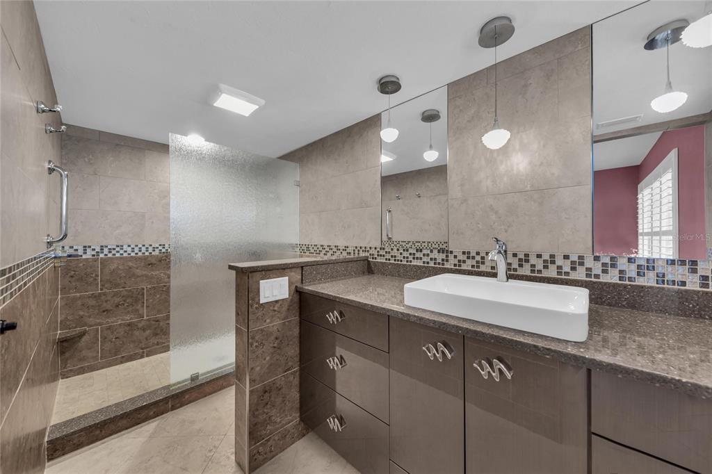 4420 Exeter Drive, Unit 307 Longboat Key, FL 34228 - Photo 15 of 37 a bathroom with a sink and a mirror