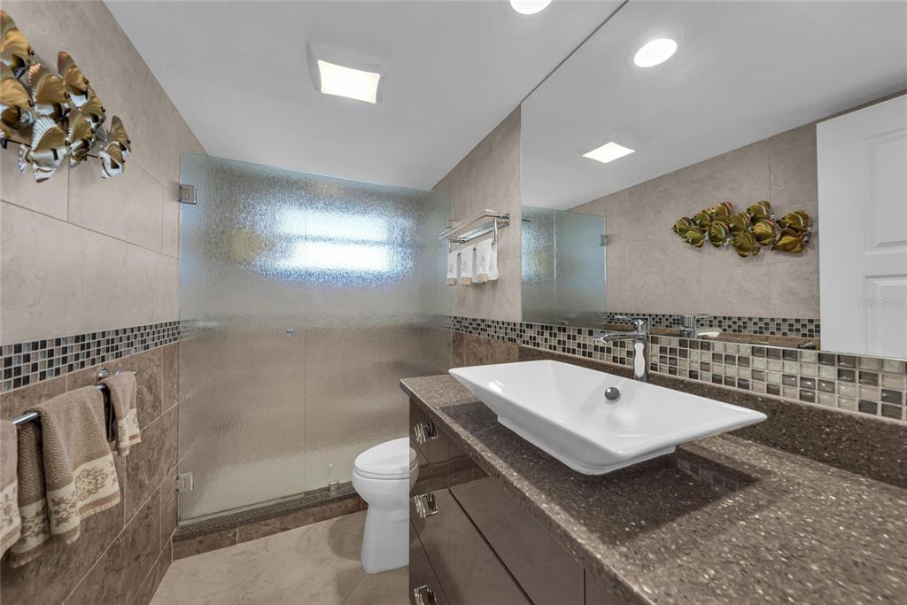 4420 Exeter Drive, Unit 307 Longboat Key, FL 34228 - Photo 17 of 37 a bathroom with a sink and a mirror