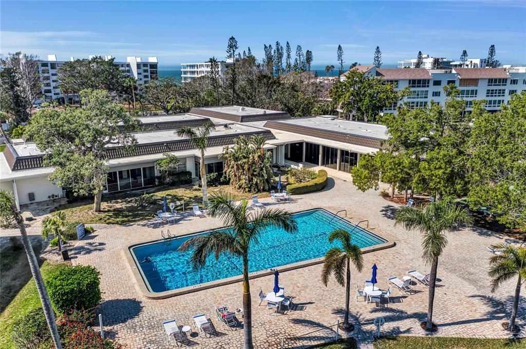 4420 Exeter Drive, Unit 307 Longboat Key, FL 34228 - Photo 21 of 37 a view of a house with pool and chairs