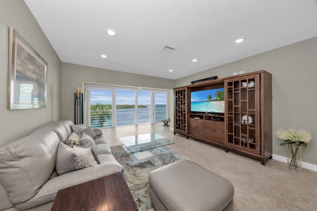 4420 Exeter Drive, Unit 307 Longboat Key, FL 34228 - Photo 5 of 37 a living room with furniture and a flat screen tv