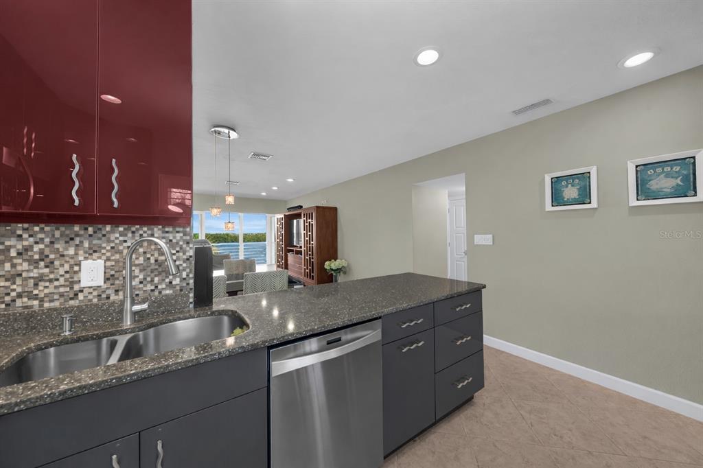 4420 Exeter Drive, Unit 307 Longboat Key, FL 34228 - Photo 10 of 37 a kitchen with a sink and a refrigerator