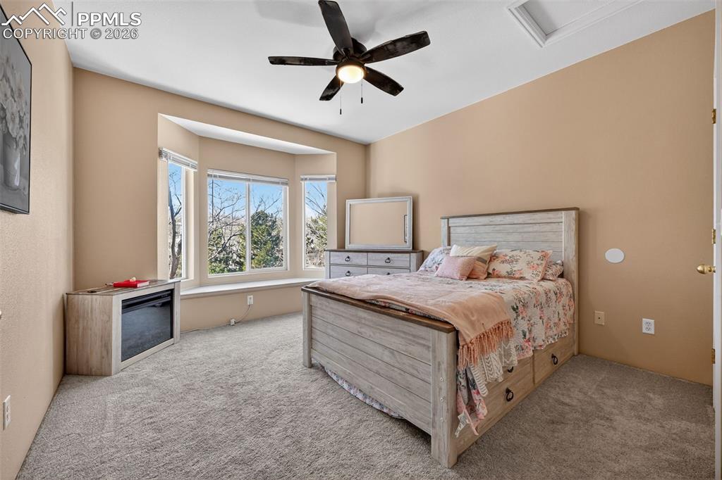 2141 Legacy Ridge View, Unit 109 Colorado Springs, CO 80910 - Photo 11 of 21 a bedroom with a bed and a large window
