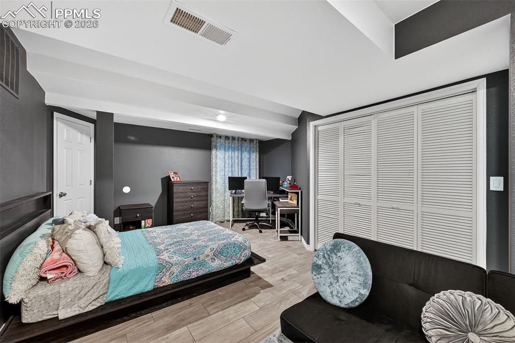 2141 Legacy Ridge View, Unit 109 Colorado Springs, CO 80910 - Photo 16 of 21 a bedroom with a bed and wooden floor