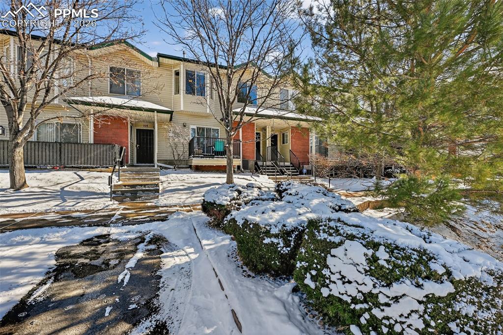 2141 Legacy Ridge View, Unit 109 Colorado Springs, CO 80910 - Photo 2 of 21 a front view of multiple houses with yard