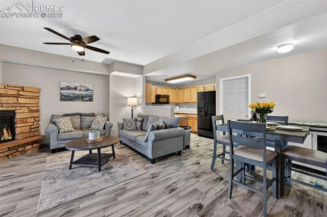 a living room with furniture and a wooden floor