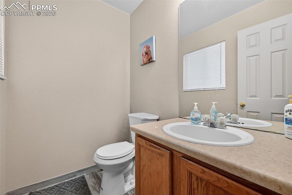 2141 Legacy Ridge View, Unit 109 Colorado Springs, CO 80910 - Photo 5 of 21 a bathroom with a granite countertop sink and a toilet