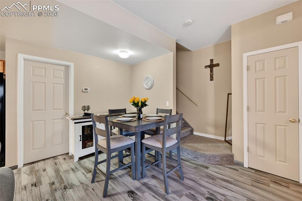 2141 Legacy Ridge View, Unit 109 Colorado Springs, CO 80910 - Photo 8 of 21 a view of a dining room with furniture and wooden floor