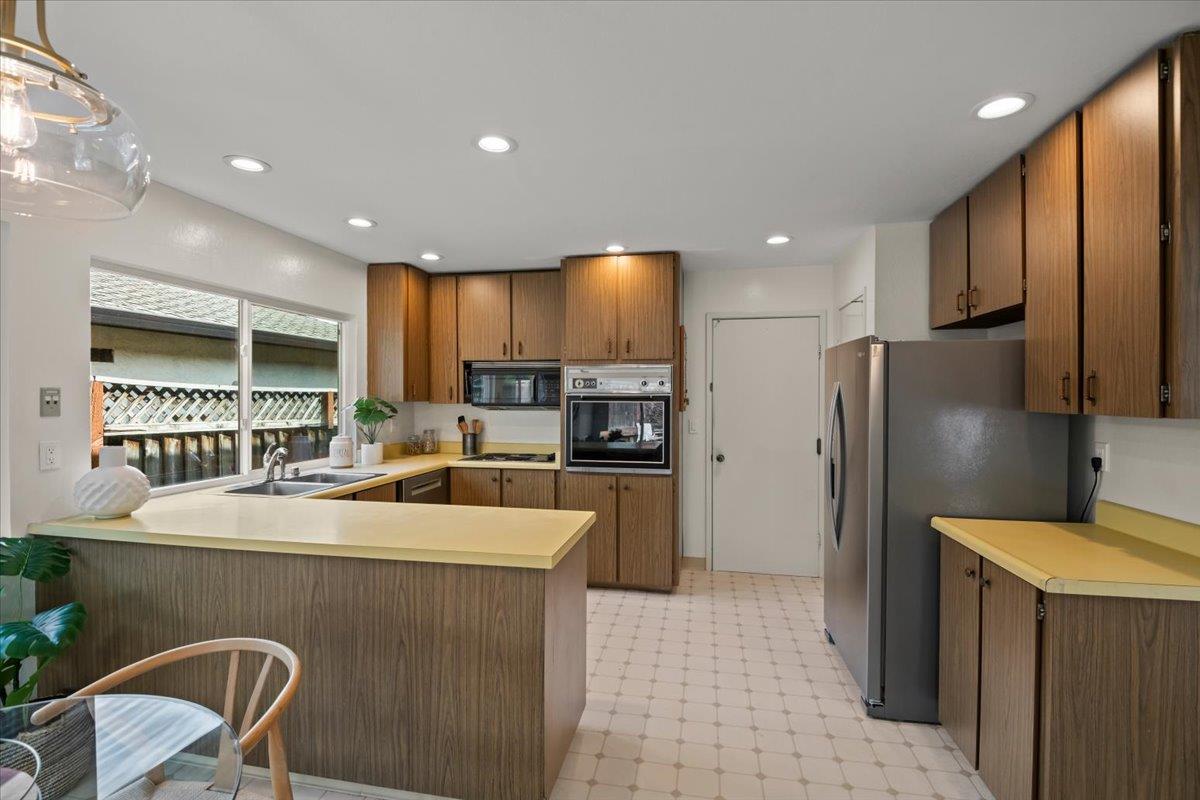 663 Smoke Tree Way Sunnyvale, CA 94086 - Photo 13 of 29 a kitchen with stainless steel appliances granite countertop a refrigerator and a stove top oven