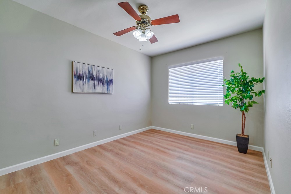 19789 Evelyn Street Corona, CA 92881 - Photo 13 of 22 a view of a room with wooden floor and a ceiling fan