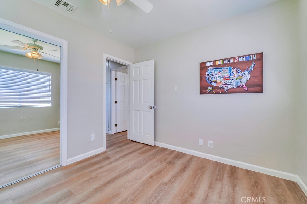 19789 Evelyn Street Corona, CA 92881 - Photo 18 of 22 an empty room with wooden floor and windows
