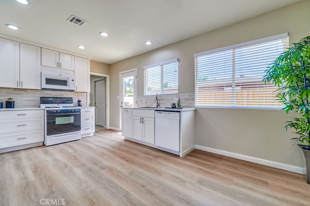 19789 Evelyn Street Corona, CA 92881 - Photo 7 of 22 a kitchen with stainless steel appliances granite countertop a stove a sink and a microwave