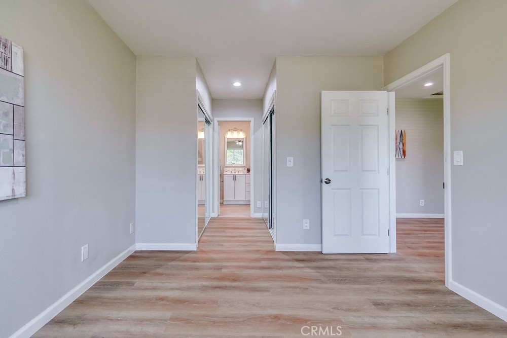 19789 Evelyn Street Corona, CA 92881 - Photo 9 of 22 a view of a hallway with wooden floor