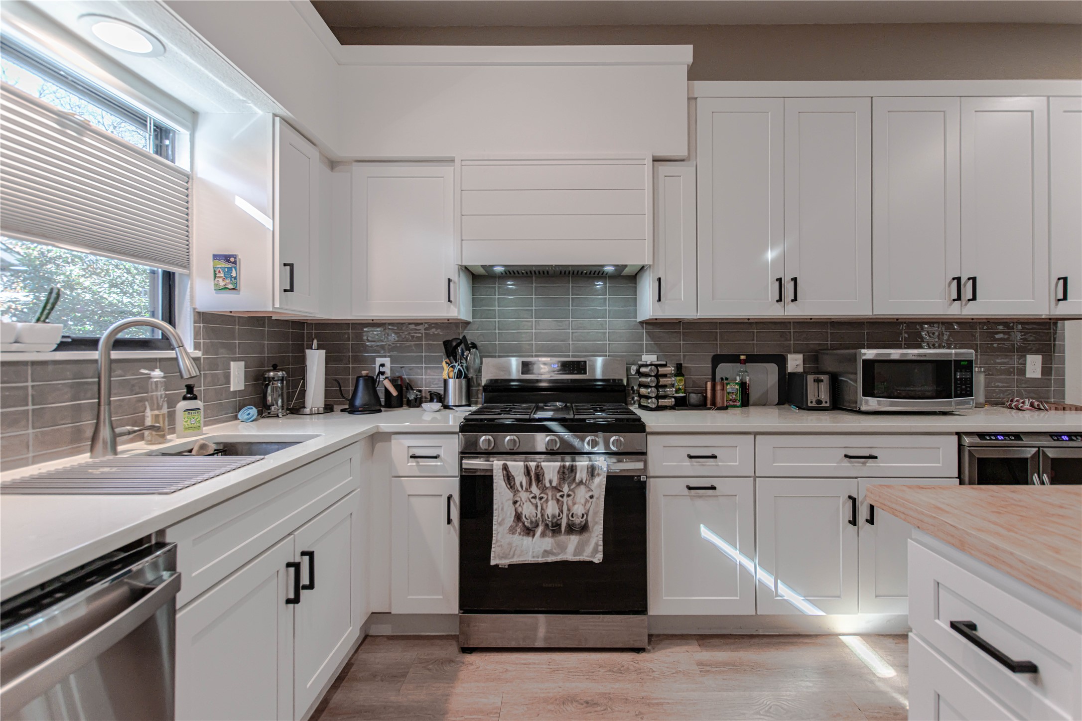 1622 Cattle Trail Austin, TX 78748 - Photo 11 of 22 a kitchen with stainless steel appliances granite countertop a stove a sink and white cabinets