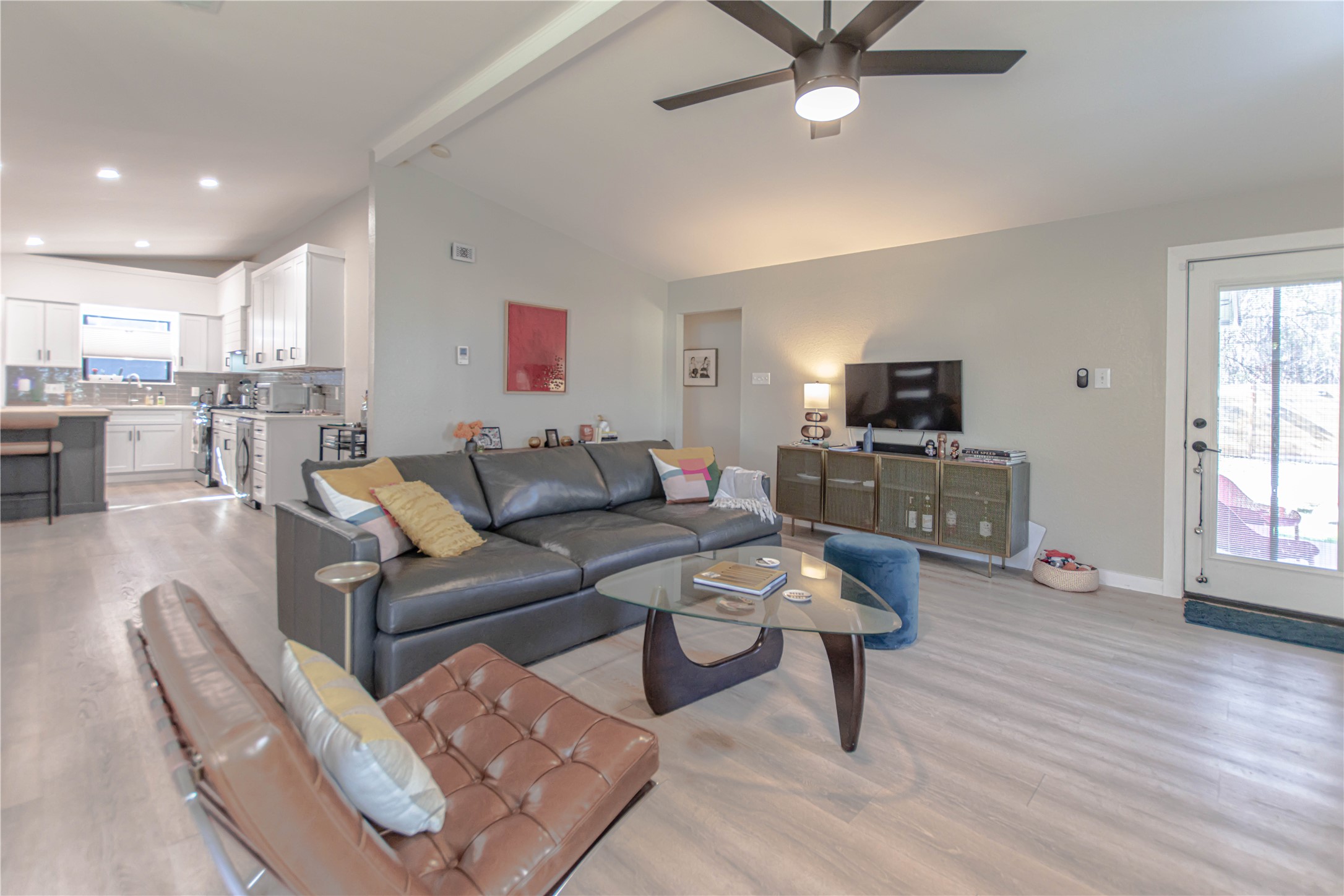 1622 Cattle Trail Austin, TX 78748 - Photo 7 of 22 a living room with furniture a ceiling fan and a flat screen tv