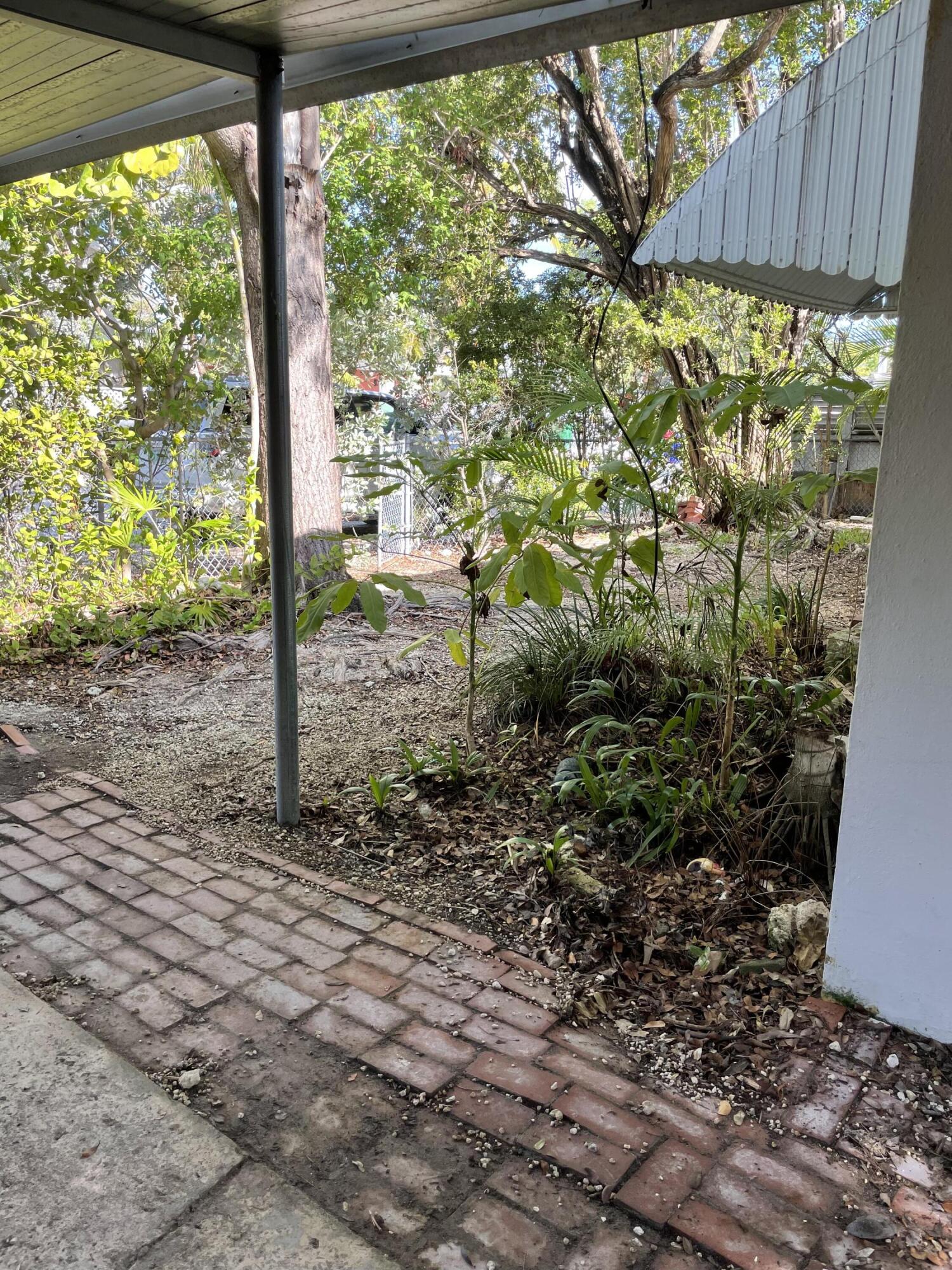 1716 Laird Street Key West, FL 33040 - Photo 28 of 32 a backyard of a house with lots of green space