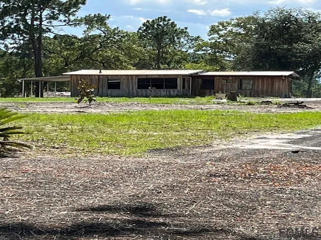 a swimming pool with outdoor seating and yard