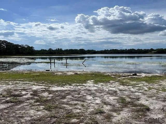 a view of a lake with houses in the back