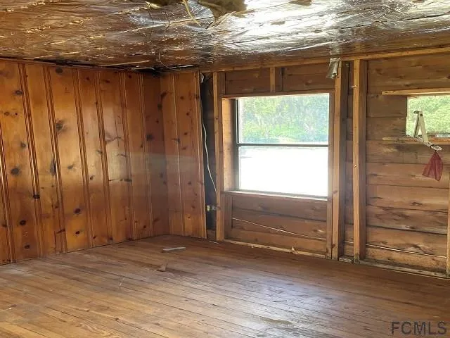 a view of room with window and wooden floor