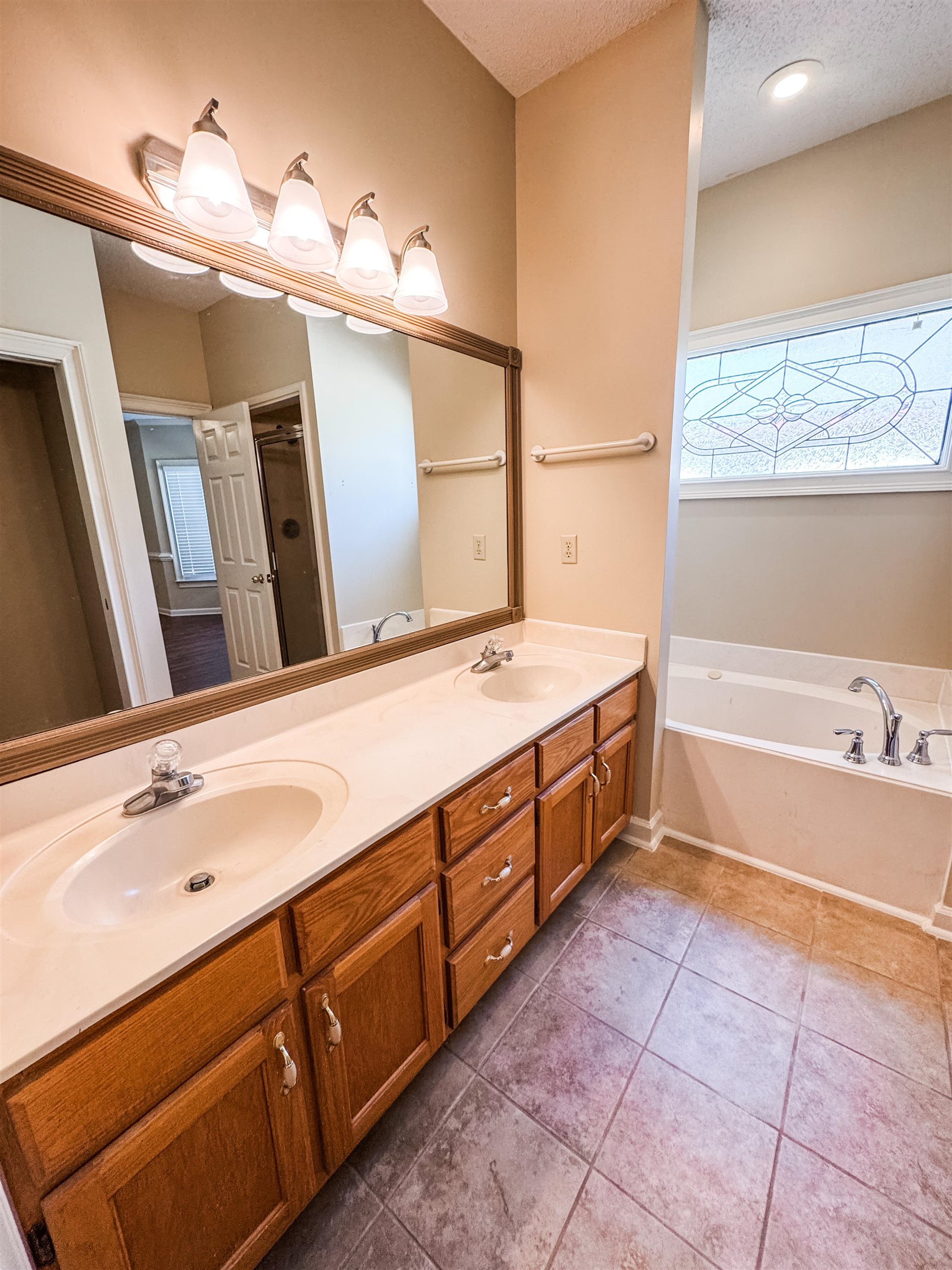 158 Eulas Ridge Cove Collierville, TN 38017 - Photo 12 of 18 Full bath with tile patterned flooring, a garden tub, double vanity, and a sink