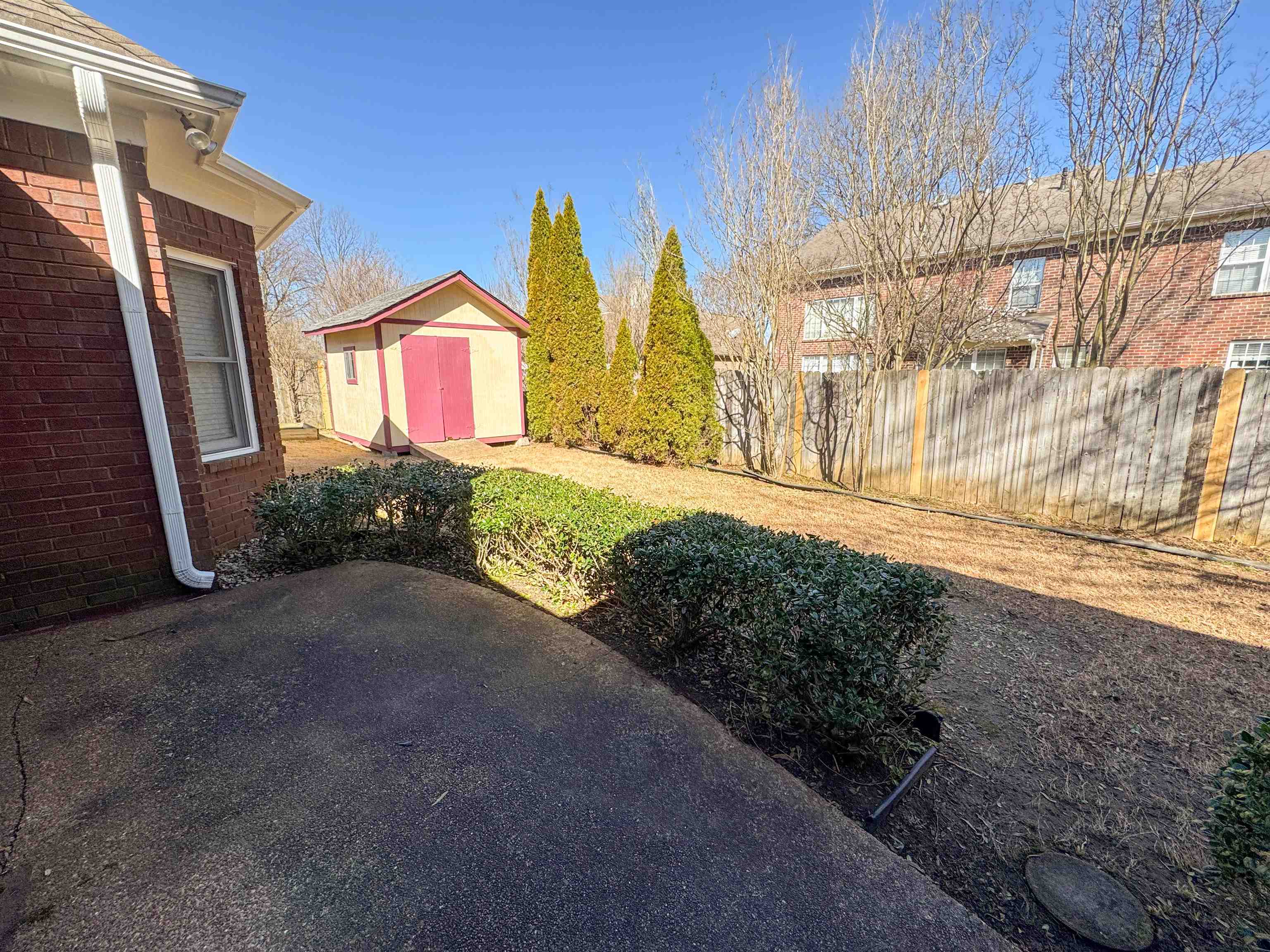 158 Eulas Ridge Cove Collierville, TN 38017 - Photo 18 of 18 View of yard with an outbuilding, a shed, a patio, and fence