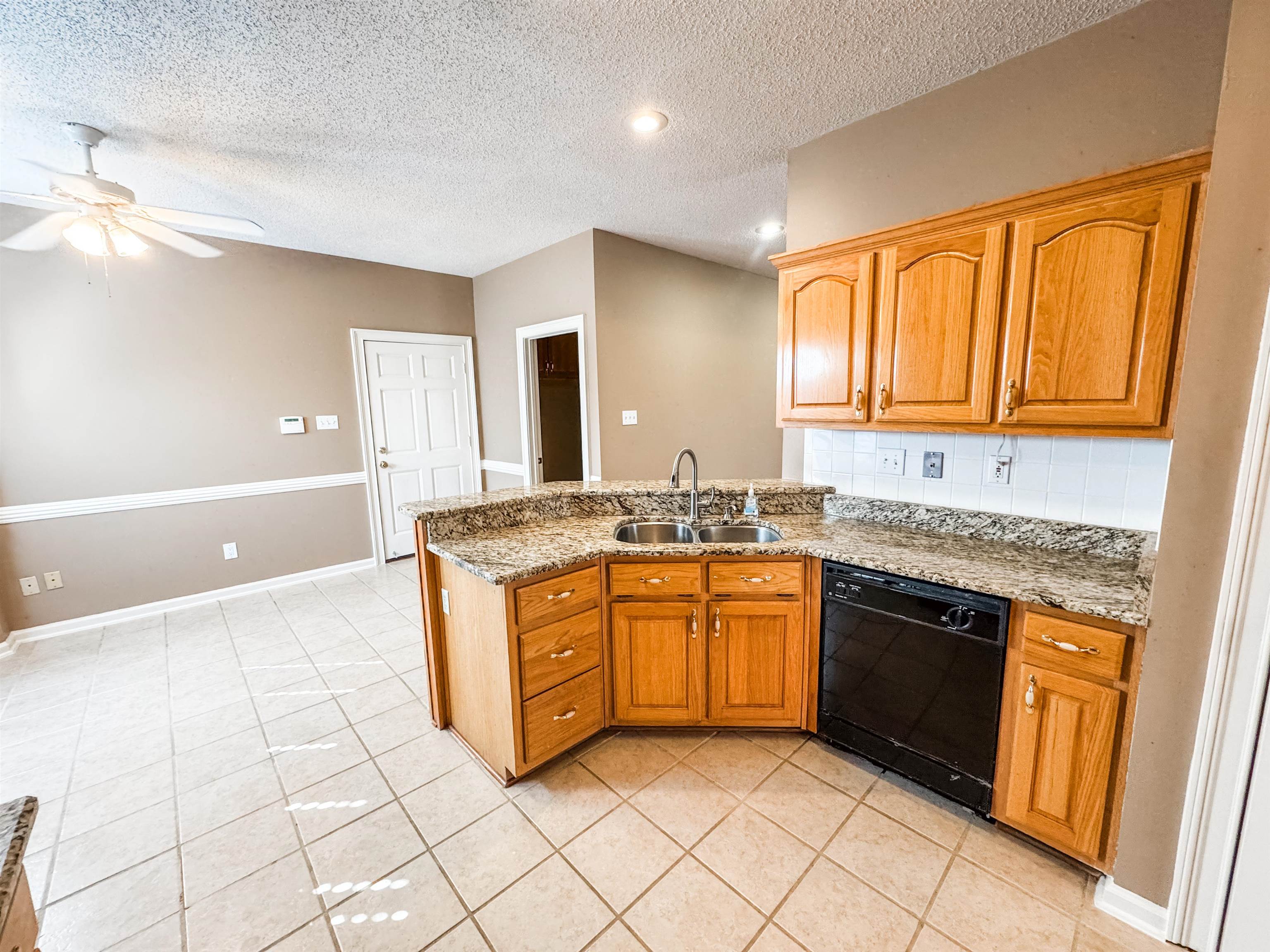 158 Eulas Ridge Cove Collierville, TN 38017 - Photo 6 of 18 Kitchen with a sink, light stone counters, tasteful backsplash, a peninsula, and dishwasher