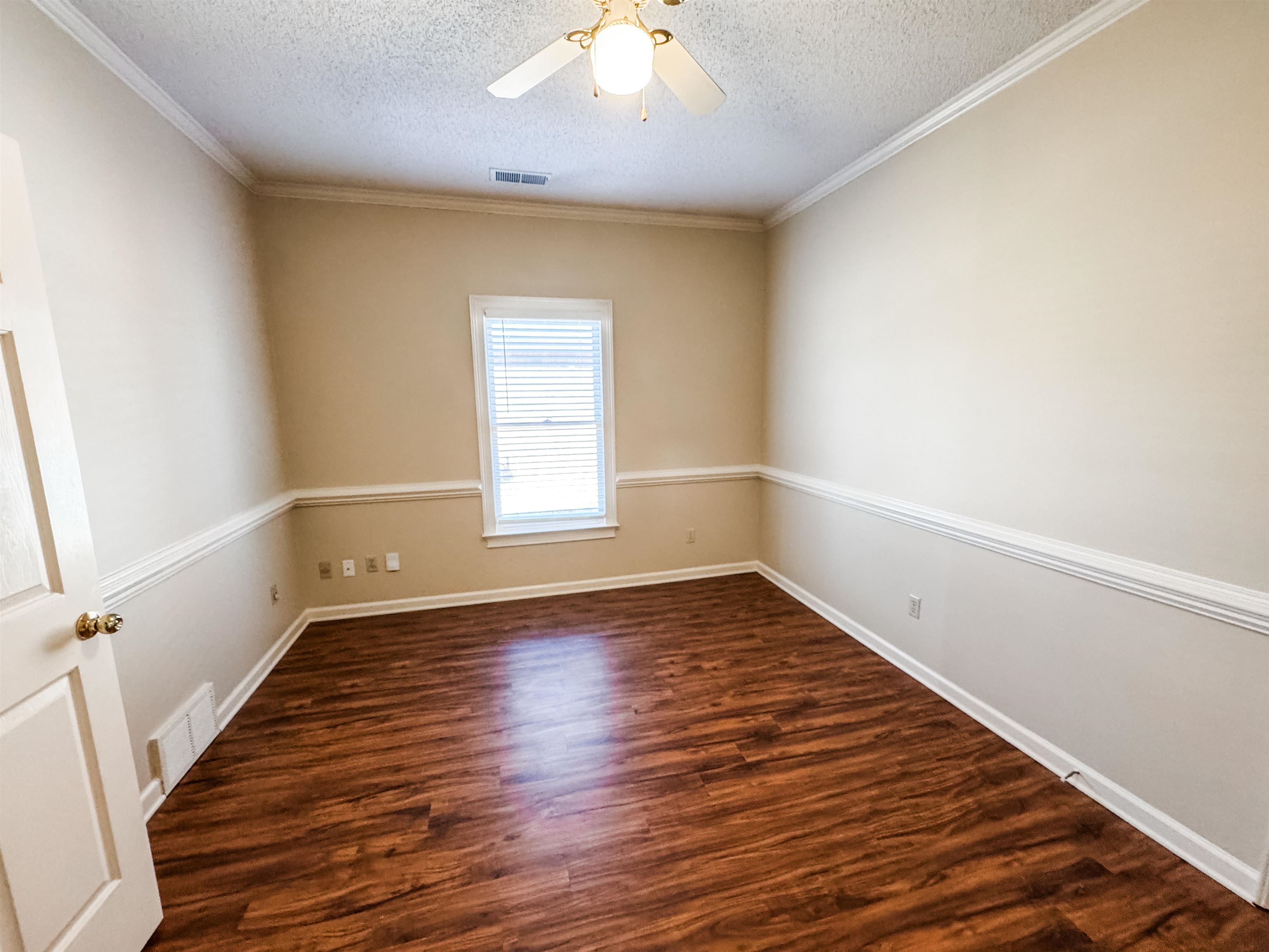 158 Eulas Ridge Cove Collierville, TN 38017 - Photo 10 of 18 Spare room featuring visible vents, a textured ceiling, ceiling fan, and dark wood-style flooring