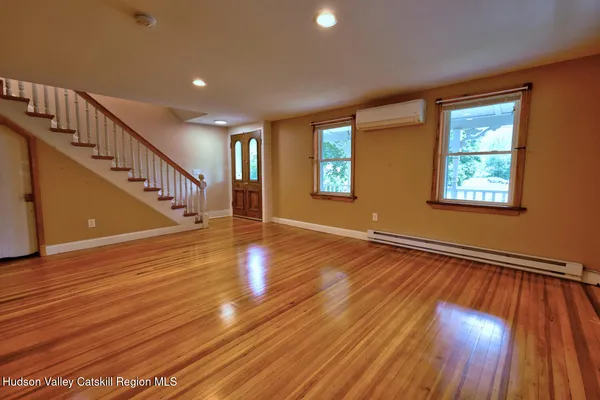 a view of an entryway with wooden floor