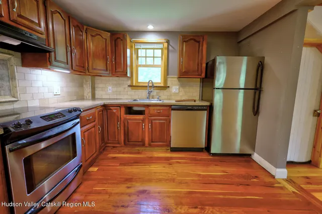 a kitchen with stainless steel appliances granite countertop a refrigerator stove and sink