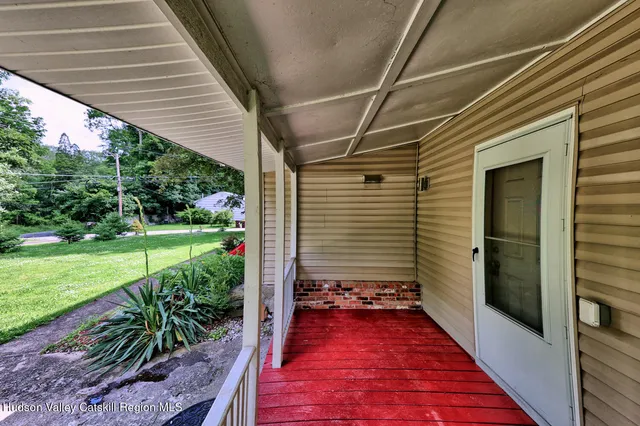 a sign board with a garden and pathway