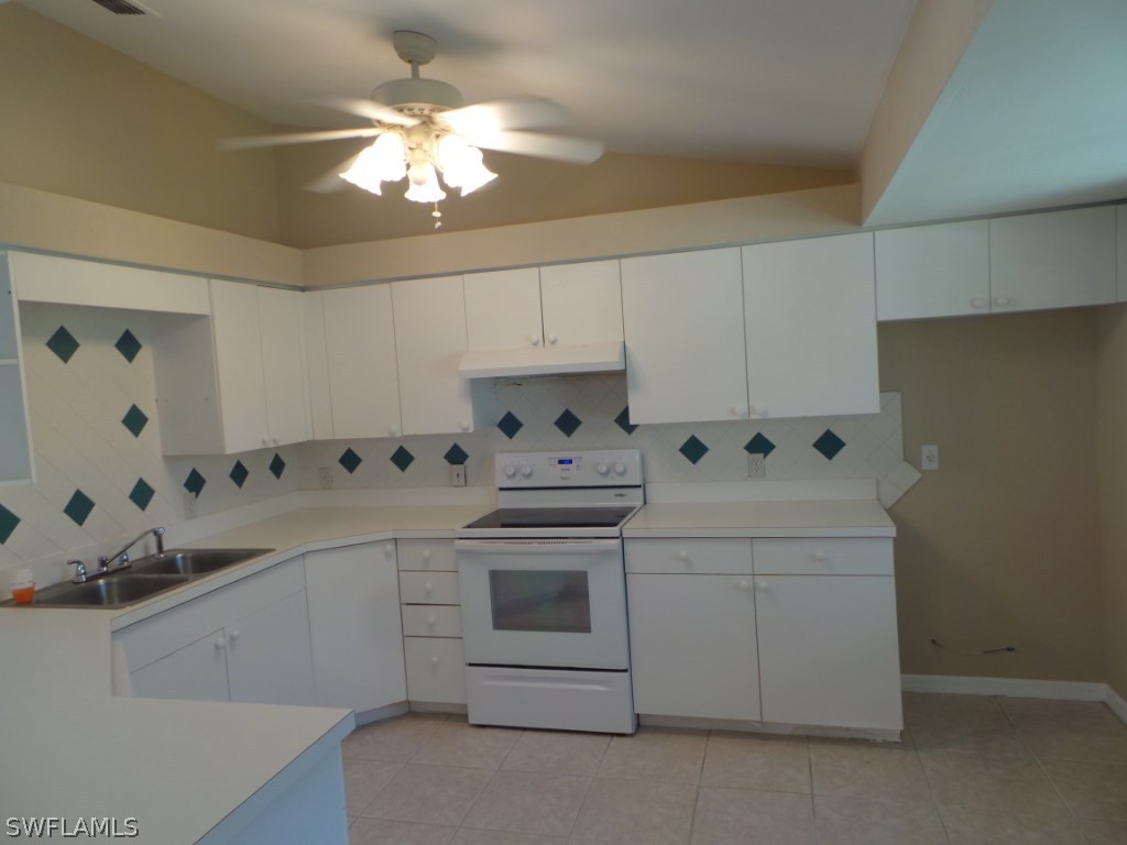 18282 Fuchsia Road Fort Myers, FL 33967 - Photo 5 of 24 a kitchen with cabinets stainless steel appliances and a chandelier