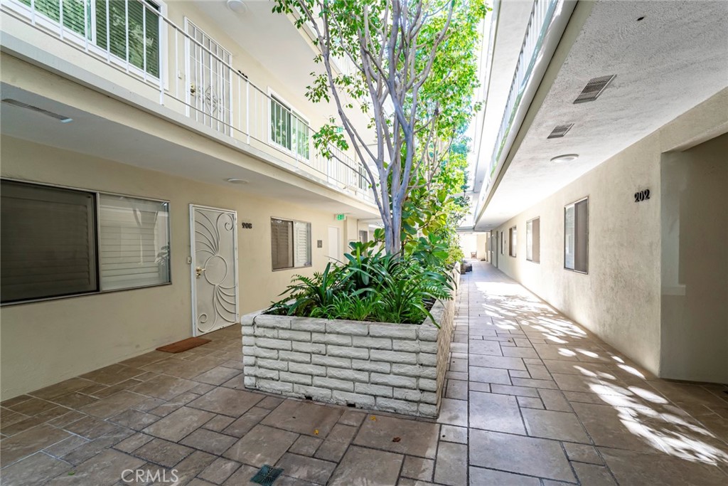 2100 2nd Street, Unit 505 Long Beach, CA 90803 - Photo 31 of 34 Interior Courtyard with Trees Reaching Up to the Top Floor
