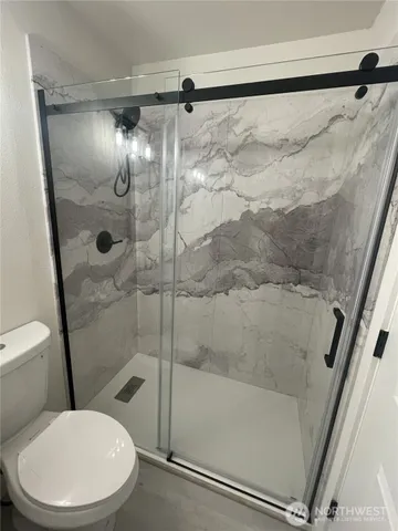 a bathroom with a toilet and shower