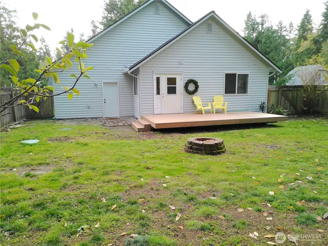 a view of a house with pool and chairs