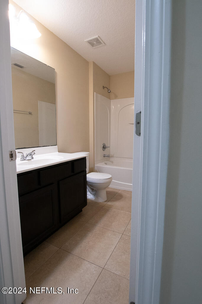 3107 Chestnut Ridge Way Orange Park, FL 32065 - Photo 13 of 22 a bathroom with a sink a toilet and a mirror
