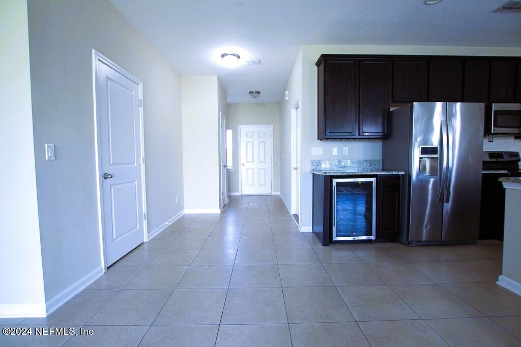3107 Chestnut Ridge Way Orange Park, FL 32065 - Photo 4 of 22 a view of kitchen with stainless steel appliances granite countertop a refrigerator and a stove top oven