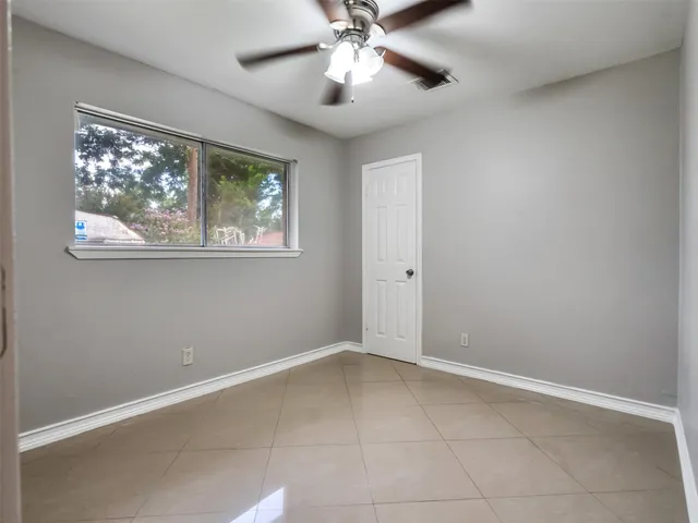 a bathroom with a granite countertop sink a toilet and a mirror