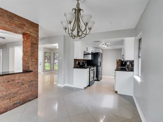 a kitchen with stainless steel appliances a stove a sink a refrigerator and cabinets