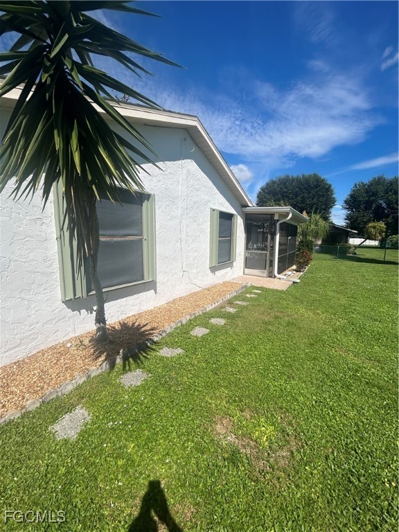16268 Shadow Pine Road North Fort Myers, FL 33917 - Photo 24 of 25 a backyard of a house with plants and palm tree