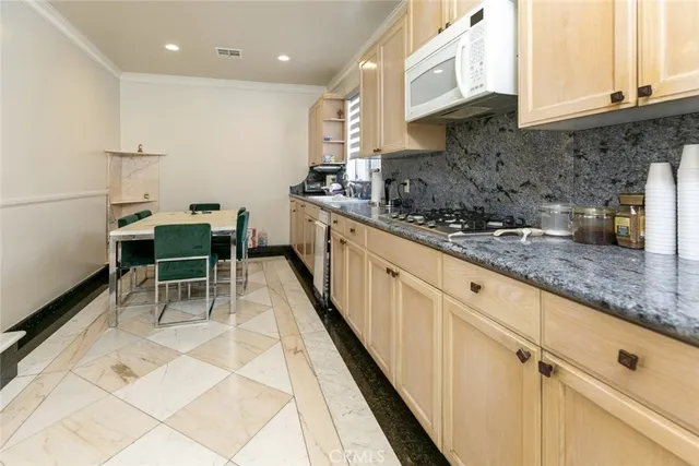 a kitchen with stainless steel appliances kitchen island granite countertop a sink and cabinets
