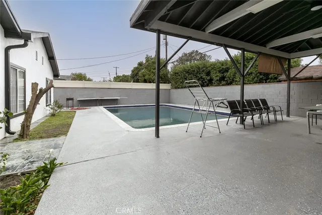 a view of a patio with table and chairs