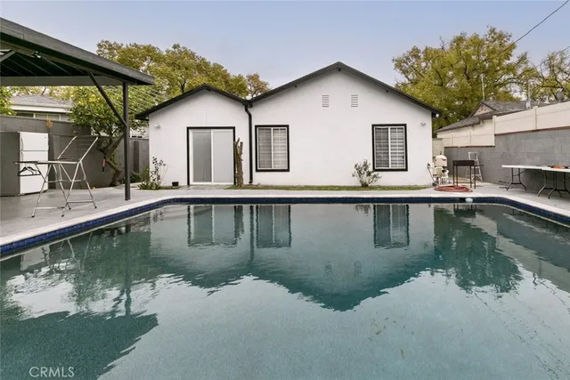a view of a house with pool and a large window