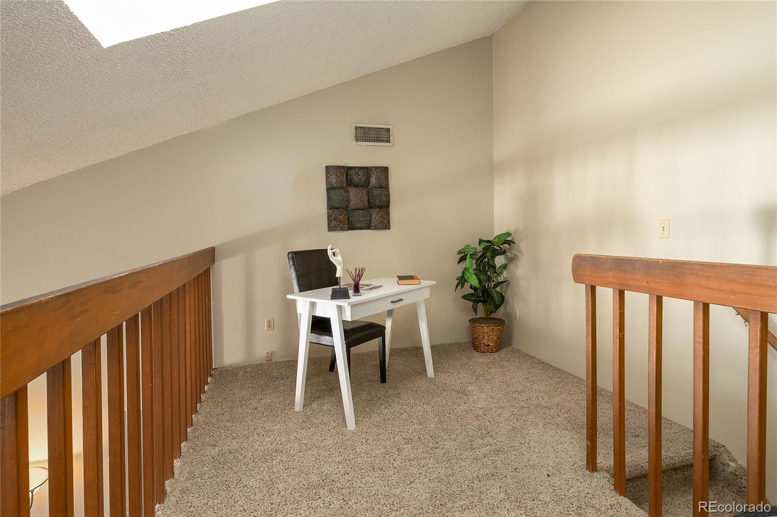 8741 Dawson Street, Unit 304 Denver, CO 80229 - Photo 12 of 27 a view of a workspace with furniture and a window