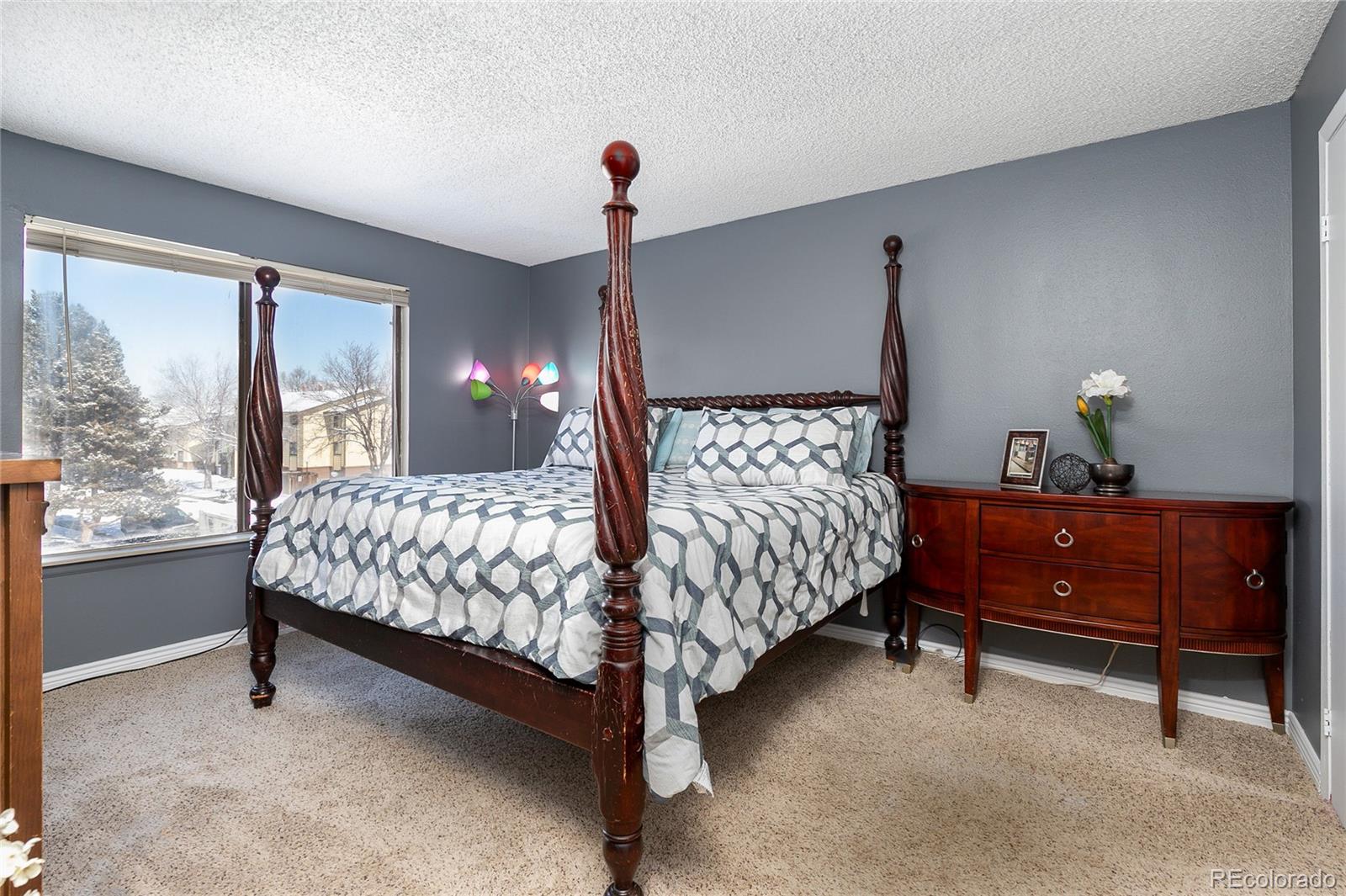 8741 Dawson Street, Unit 304 Denver, CO 80229 - Photo 15 of 27 a bedroom with a bed and a window