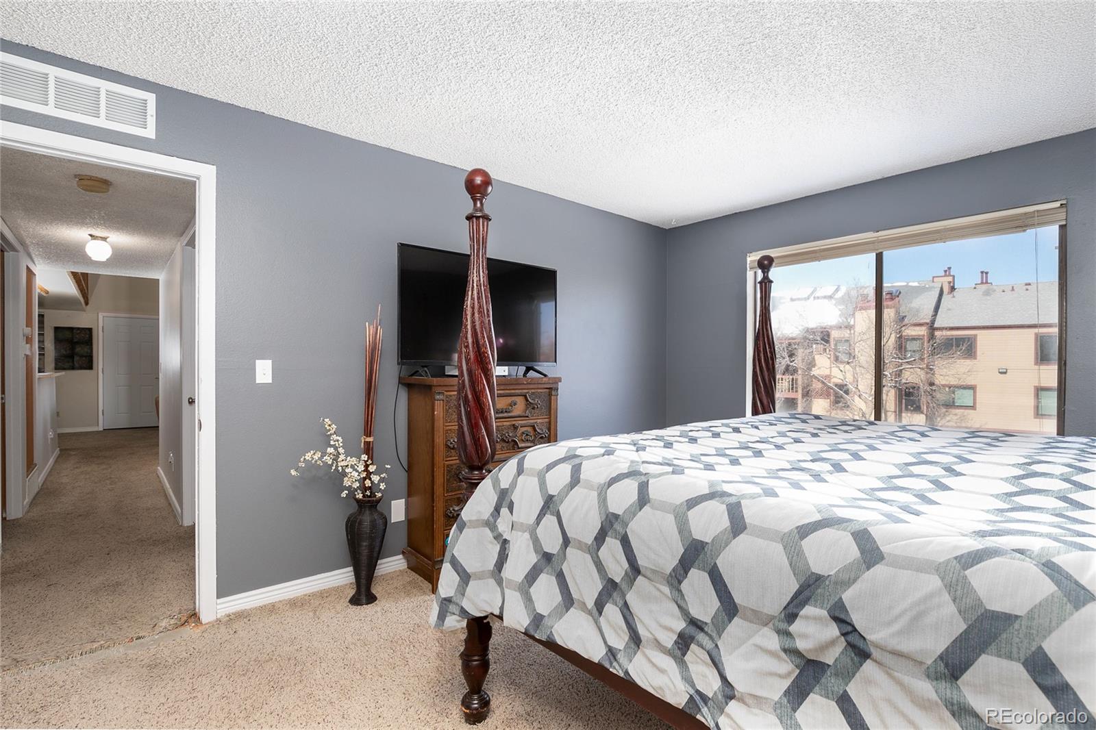 8741 Dawson Street, Unit 304 Denver, CO 80229 - Photo 16 of 27 a bedroom with a bed and a window