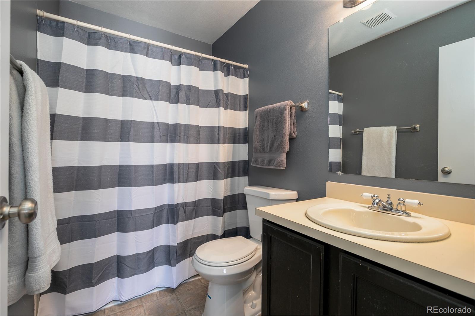 8741 Dawson Street, Unit 304 Denver, CO 80229 - Photo 19 of 27 a bathroom with a sink toilet and shower