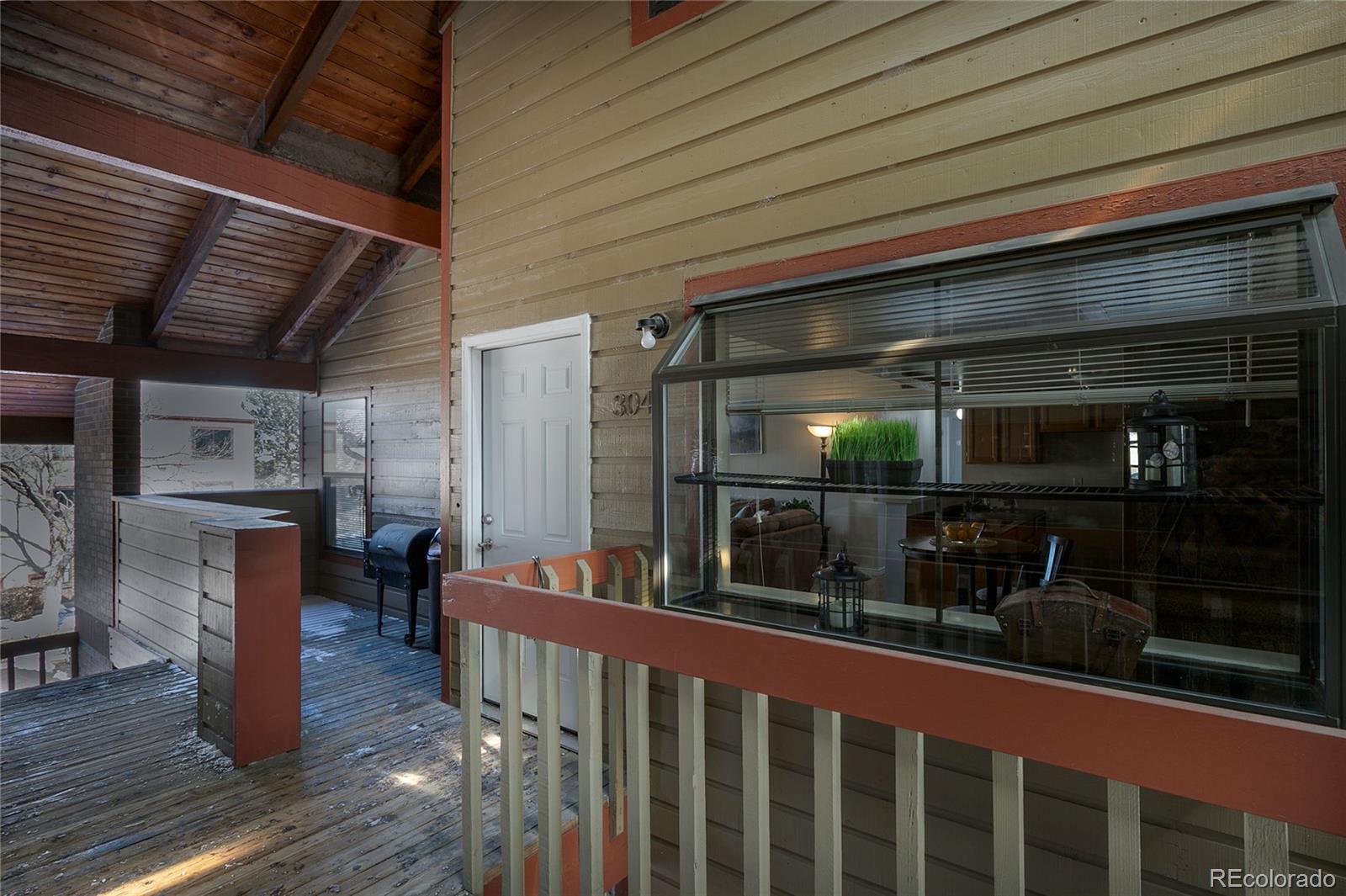 8741 Dawson Street, Unit 304 Denver, CO 80229 - Photo 26 of 27 a view of a porch with wooden floor