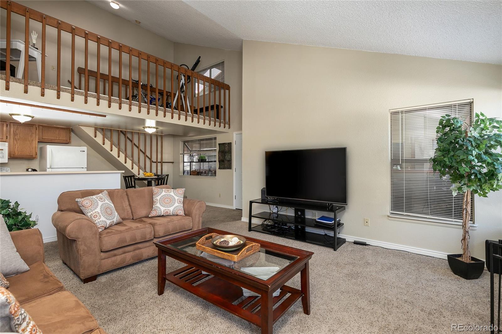 8741 Dawson Street, Unit 304 Denver, CO 80229 - Photo 6 of 27 a living room with furniture and a flat screen tv