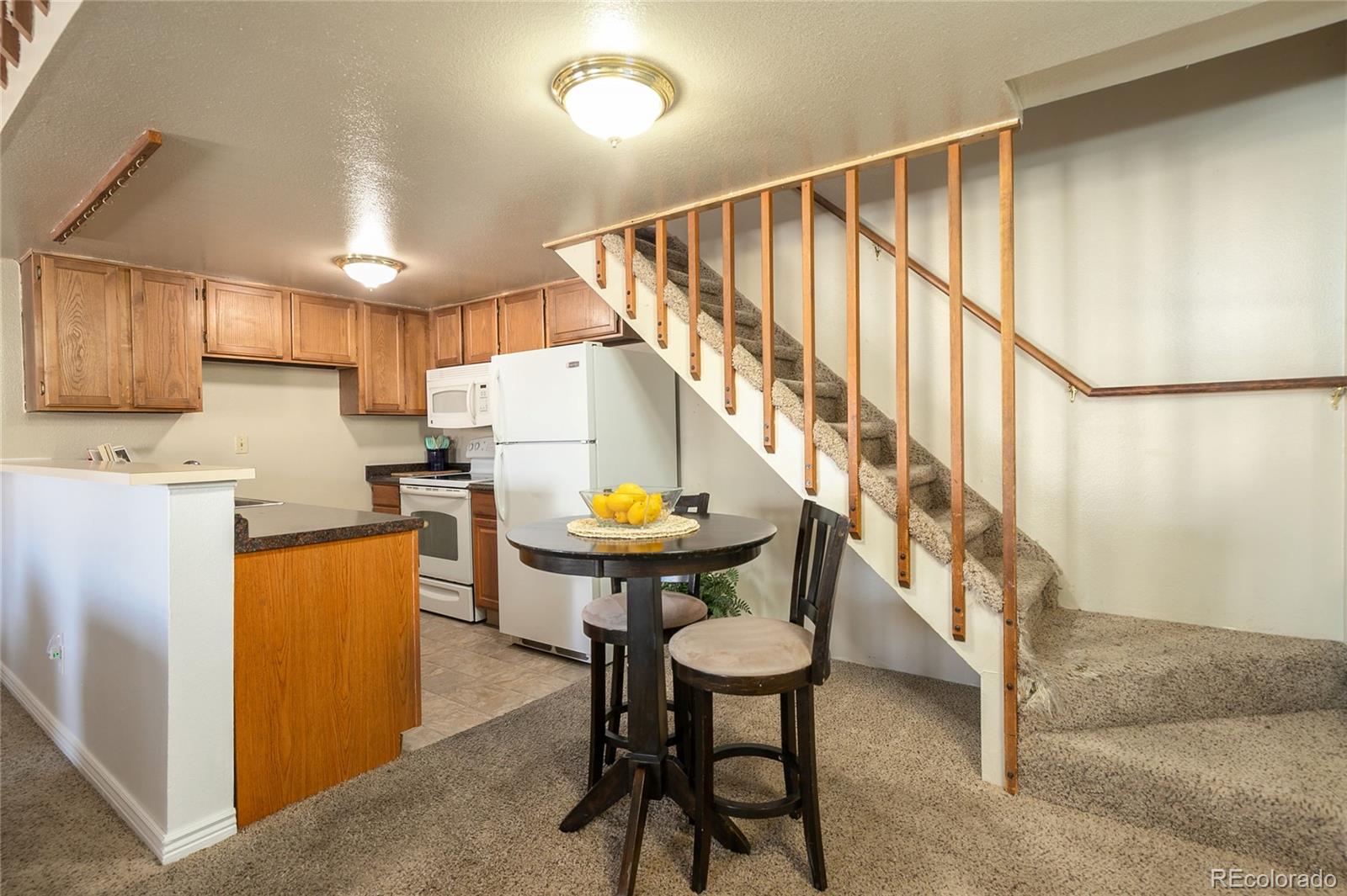 8741 Dawson Street, Unit 304 Denver, CO 80229 - Photo 8 of 27 a kitchen with sink and a refrigerator