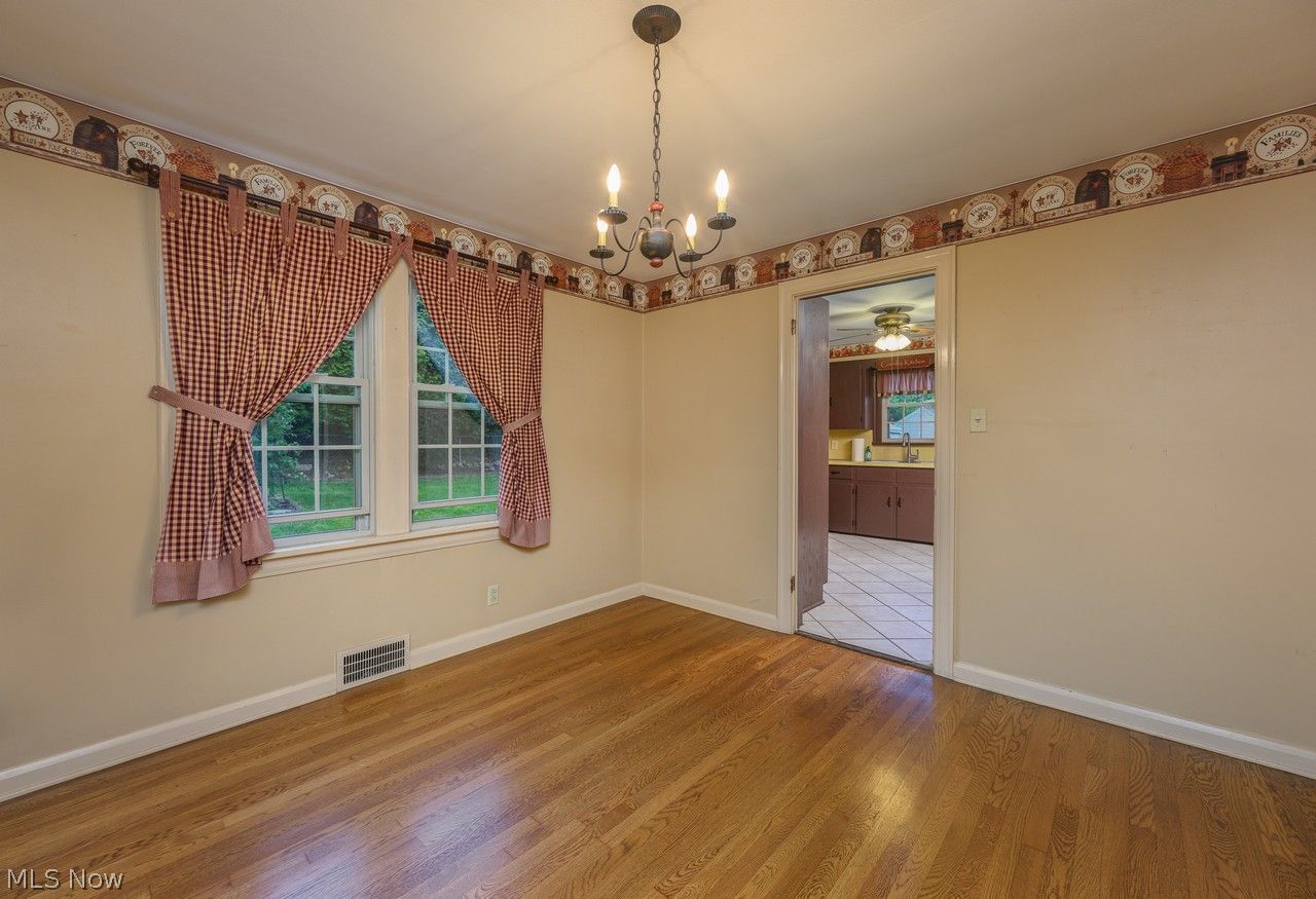 1422 Monument Road Northwest Canton, OH 44703 - Photo 10 of 31 Dining room with multiple windows and hardwood floors